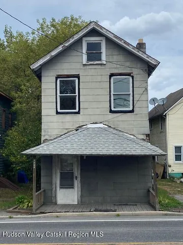 a view of brick house with large windows