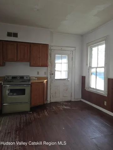 a kitchen with granite countertop wooden floors and stainless steel appliances