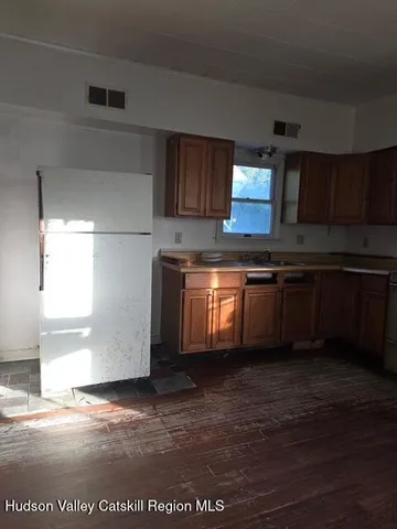 a kitchen with granite countertop a sink and a stove top oven