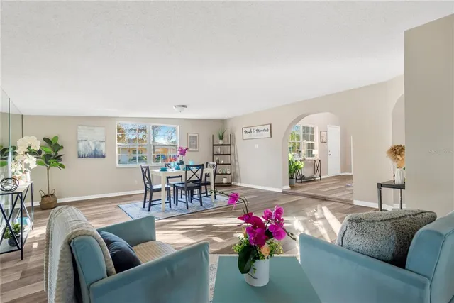 a living room with furniture and flowers