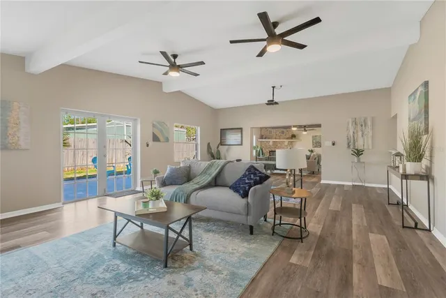 a living room with furniture a ceiling fan and a rug
