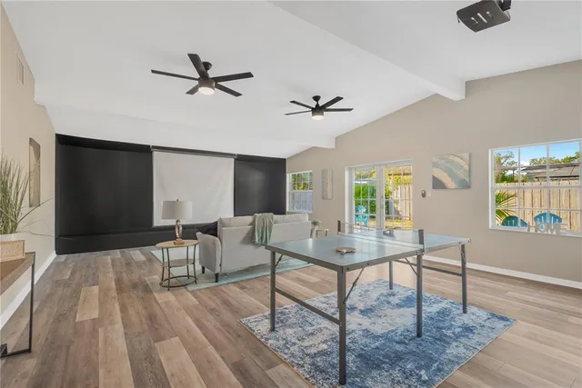 a view of a livingroom with furniture window and wooden floor