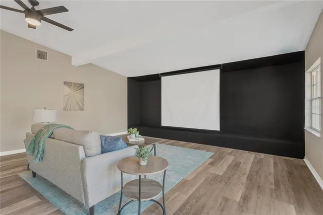 a front view of a house with a garden and trees