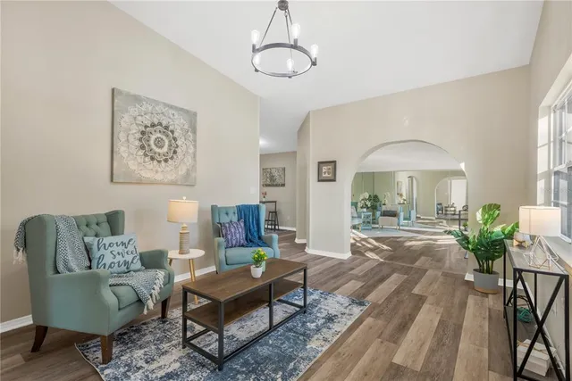a living room with furniture and a chandelier