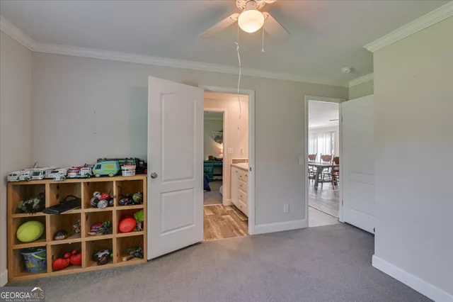 a view of an empty room with cabinet and rack