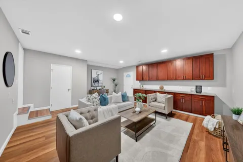 a living room with furniture and a wooden floor