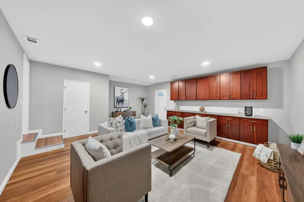 a living room with furniture and a wooden floor