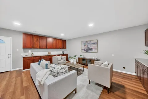 a living room with furniture and a wooden floor