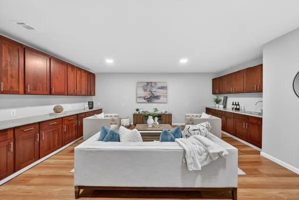 a living room with furniture and a wooden floor