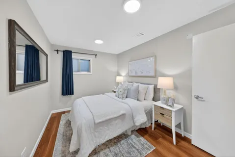 a bedroom with a bed and a night stand