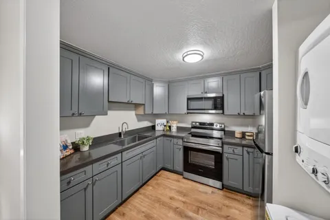 a kitchen with a sink stove and refrigerator