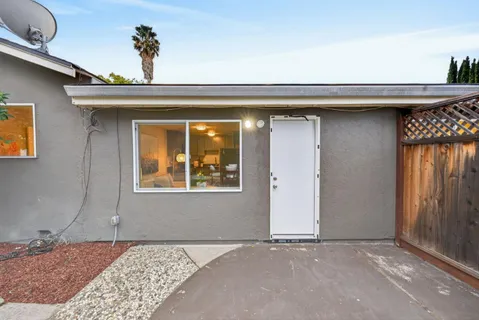 a living room with furniture and a dining table with kitchen view