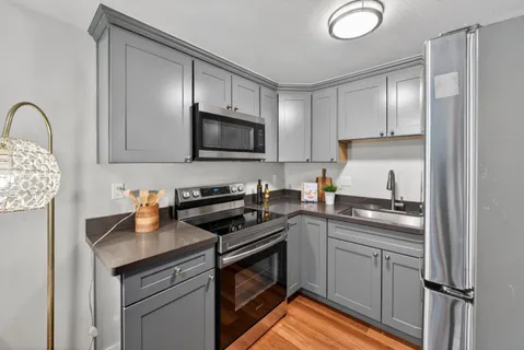 a kitchen with a refrigerator and a sink