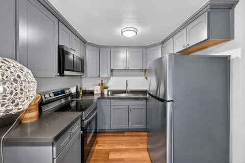 a bedroom with a bed and a painting on the wall