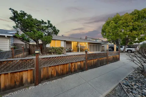 a view of a house with wooden fence