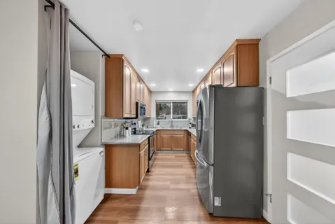 a kitchen with a refrigerator and a stove