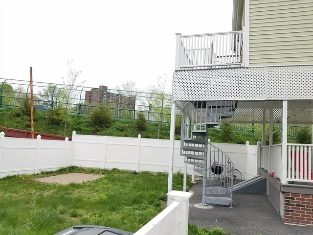 a view of house with a yard from a balcony