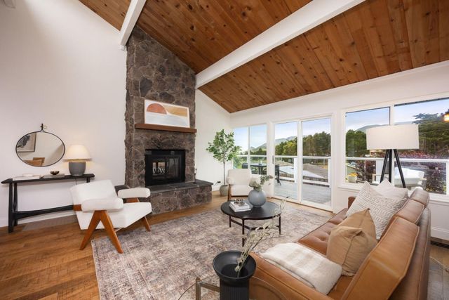 a living room with furniture a rug and a fireplace