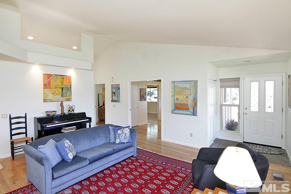 560 Citadel Road Reno, NV 89503 - Photo 8 of 25 a living room with furniture a wooden floor and a bookshelf