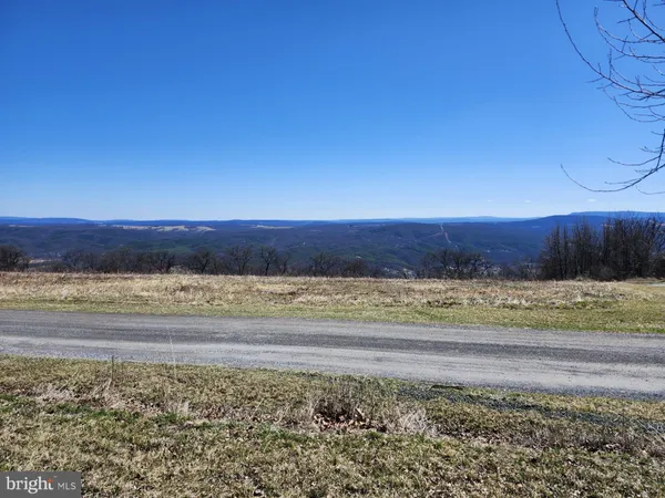 a view of a yard with wooden fence