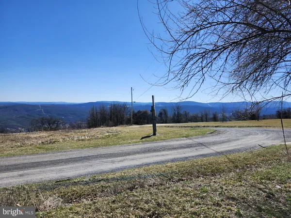 a view of a yard covered with snow in the background