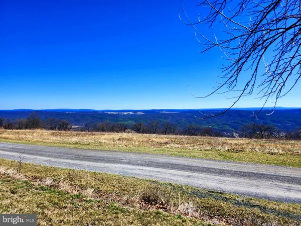 a view of ocean with green space