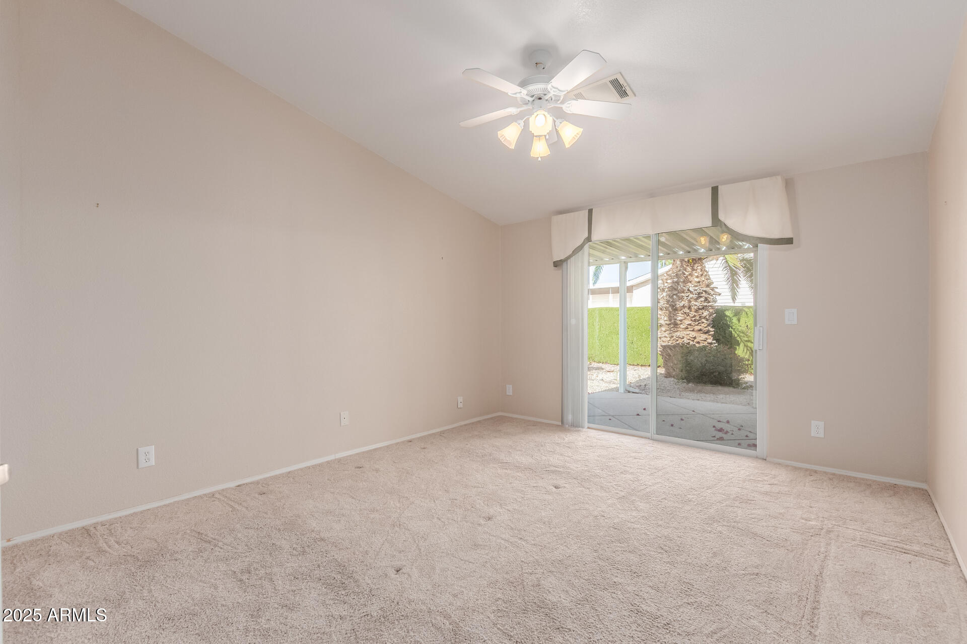 2550 South Ellsworth Road, Unit 366 Mesa, AZ 85209 - Photo 13 of 27 an empty room that has a chandelier fan and a chandelier fan