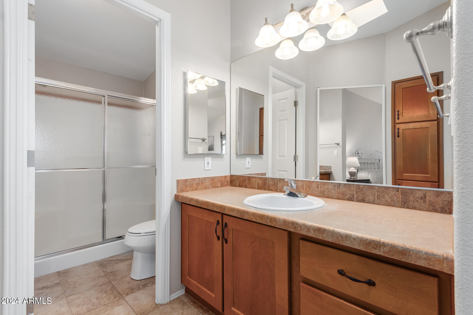 2550 South Ellsworth Road, Unit 366 Mesa, AZ 85209 - Photo 15 of 27 a bathroom with a granite countertop sink a toilet and a mirror