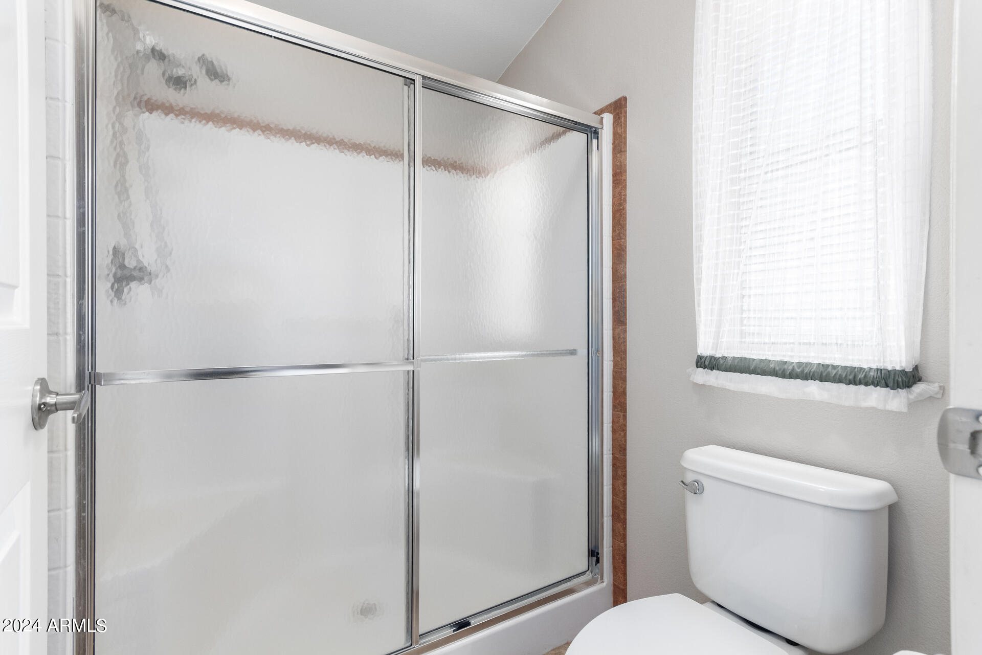 2550 South Ellsworth Road, Unit 366 Mesa, AZ 85209 - Photo 17 of 27 a bathroom with a shower and a toilet