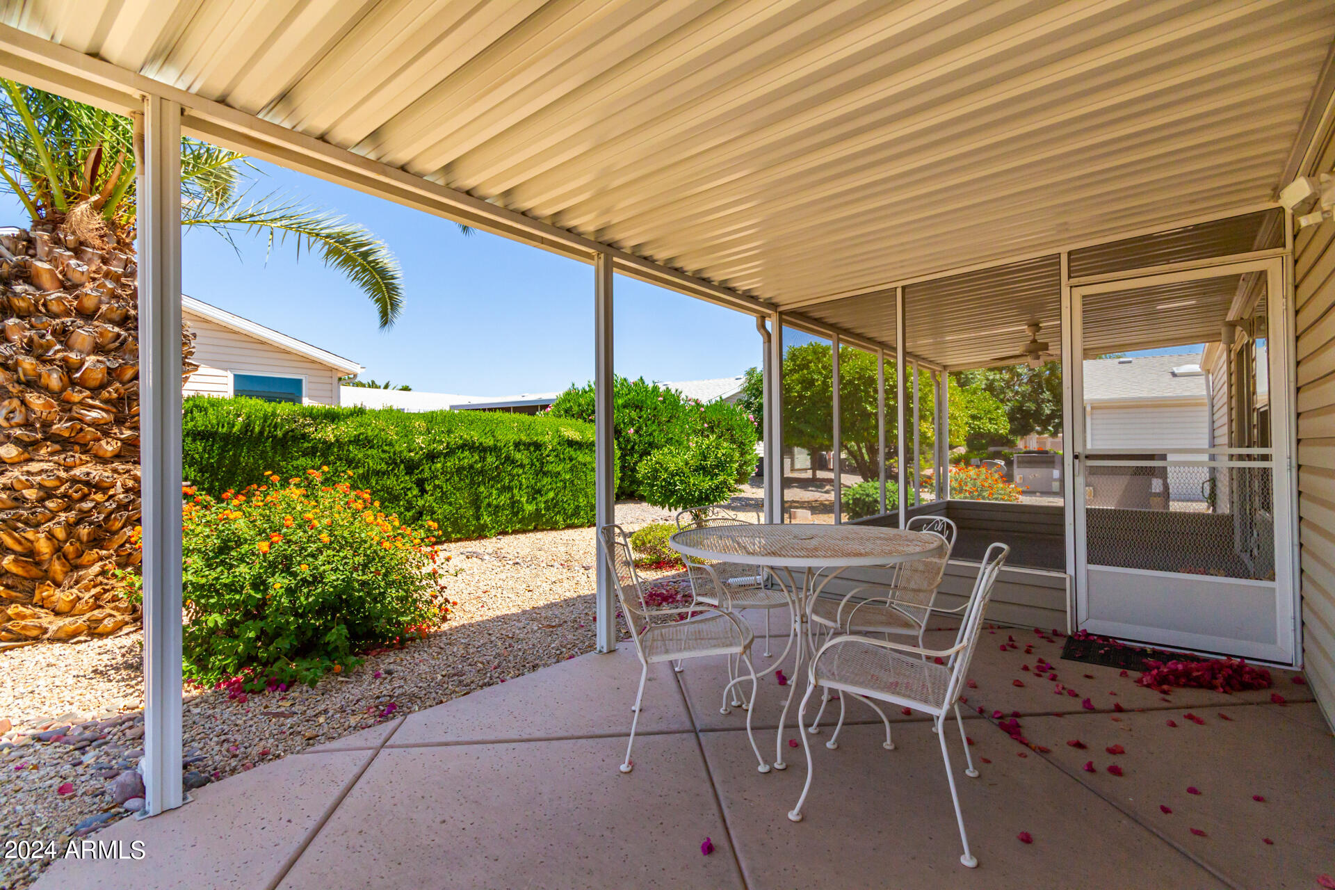 2550 South Ellsworth Road, Unit 366 Mesa, AZ 85209 - Photo 25 of 27 a view of a patio with table and chairs and potted plants