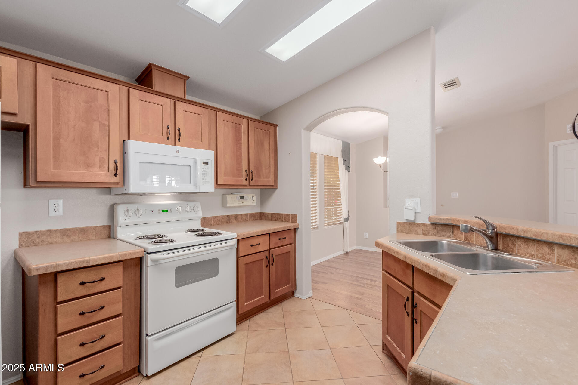 2550 South Ellsworth Road, Unit 366 Mesa, AZ 85209 - Photo 10 of 27 a kitchen with a sink stove and cabinets