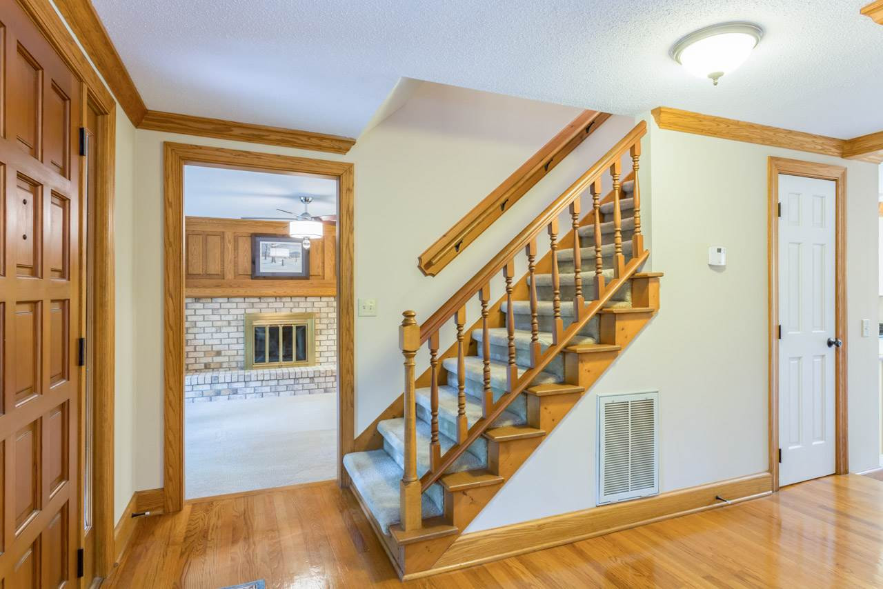 5200 Country Trail Raleigh, NC 27613 - Photo 3 of 25 Passageway to sunken family room. Stairs go up to 3 nice size bedrooms. Powder room off foyer. Entry