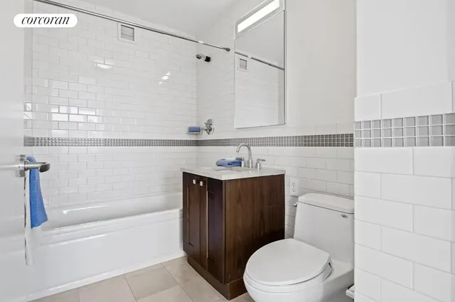 a spacious bathroom with a double vanity sink a large mirror and a shower