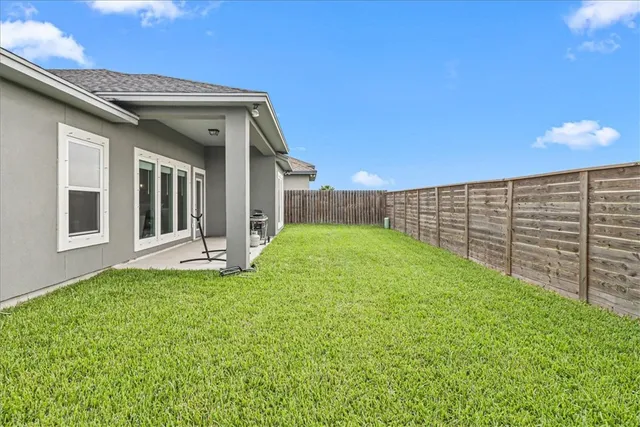 a view of a house with backyard and porch