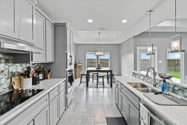 a large kitchen with stainless steel appliances lots of counter top space