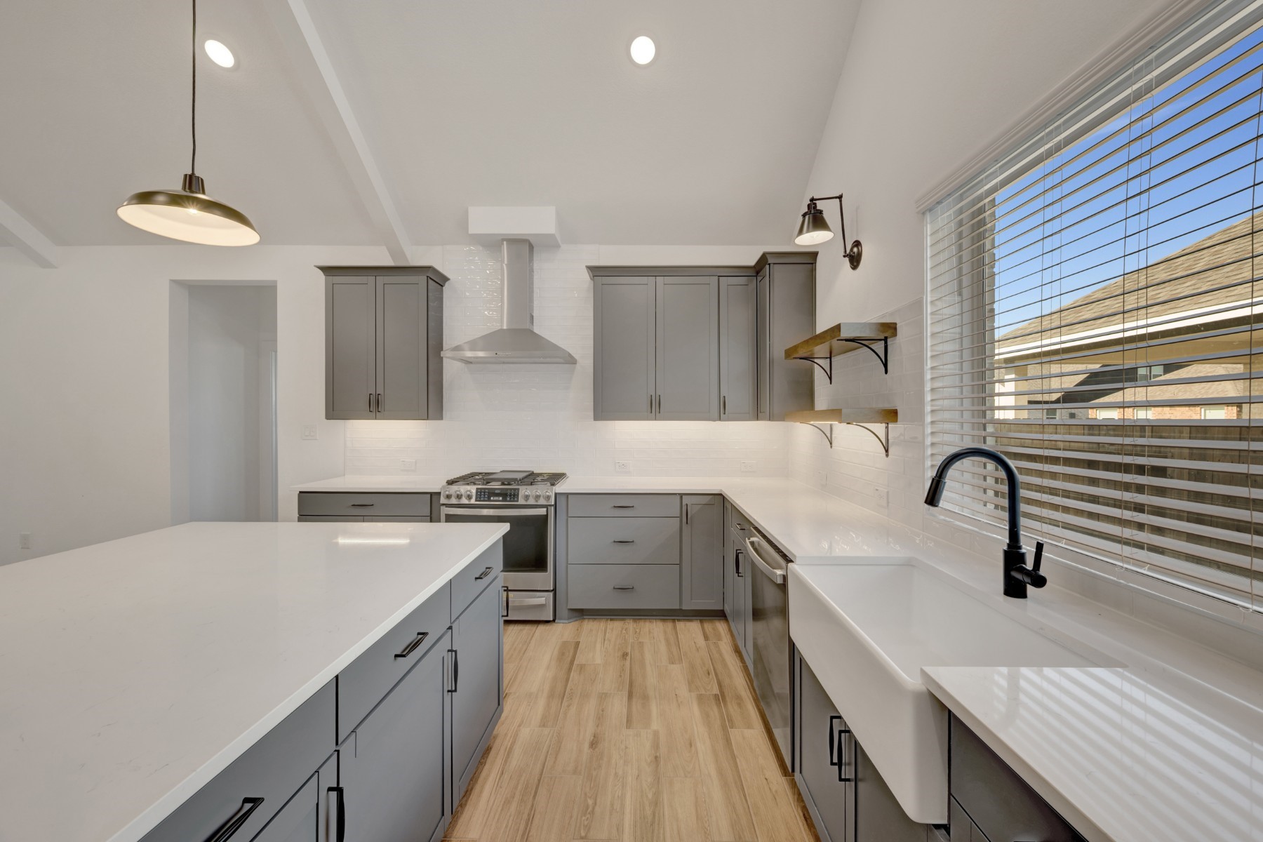 2523 Good Morrow Drive Rosenberg, TX 77471 - Photo 9 of 50 Stylish kitchen with grey cabinets and floating shelves