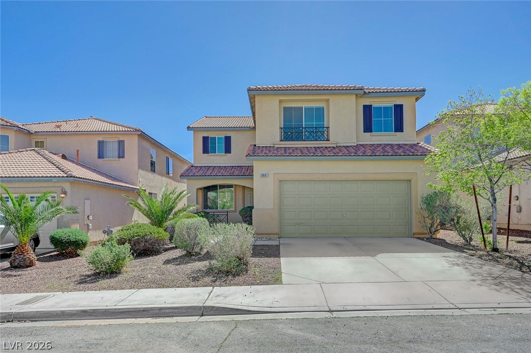 9687 Ridgebluff Avenue Las Vegas, NV 89148 - Photo 1 of 57 Mediterranean / spanish house featuring concrete driveway, stucco siding, an attached garage, and a tiled roof