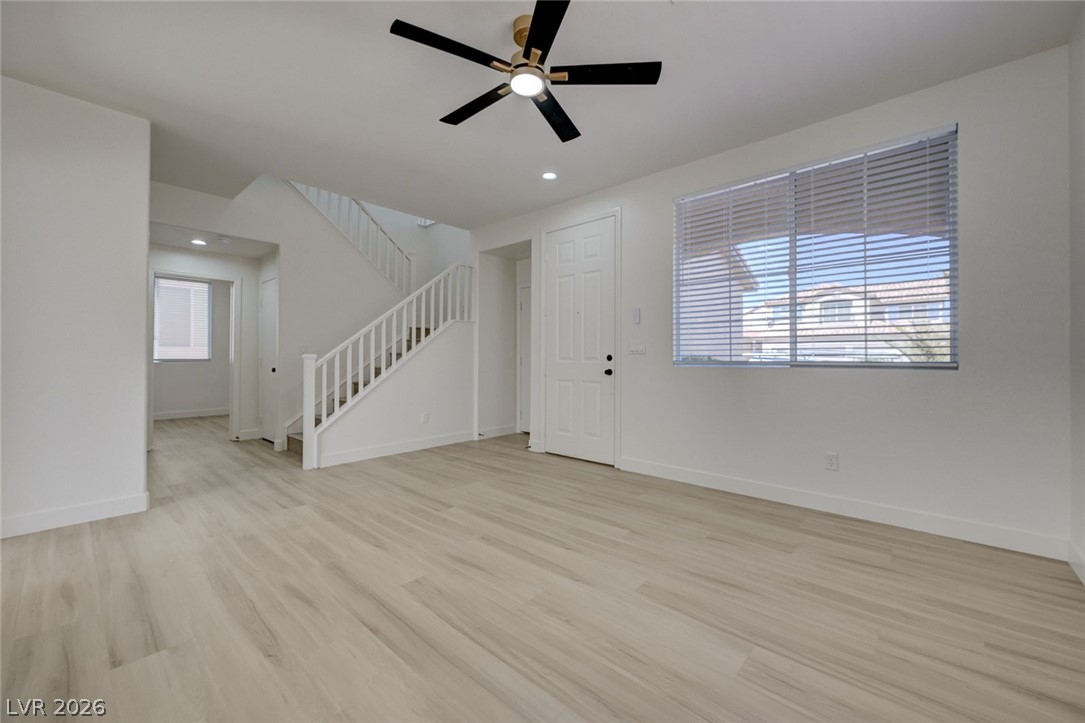 9687 Ridgebluff Avenue Las Vegas, NV 89148 - Photo 21 of 57 Unfurnished living room featuring light wood finished floors, a ceiling fan, plenty of natural light, and recessed lighting