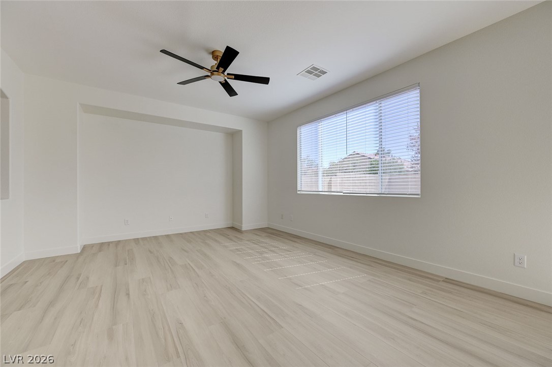9687 Ridgebluff Avenue Las Vegas, NV 89148 - Photo 24 of 57 Unfurnished room with a ceiling fan and light wood-type flooring
