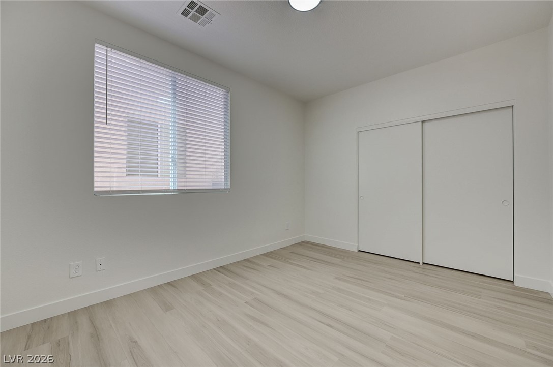 9687 Ridgebluff Avenue Las Vegas, NV 89148 - Photo 27 of 57 Unfurnished bedroom with light wood-type flooring and a closet