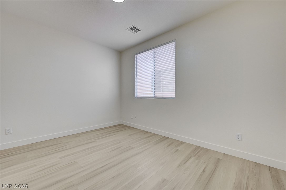 9687 Ridgebluff Avenue Las Vegas, NV 89148 - Photo 28 of 57 Unfurnished room with baseboards and light wood-style flooring