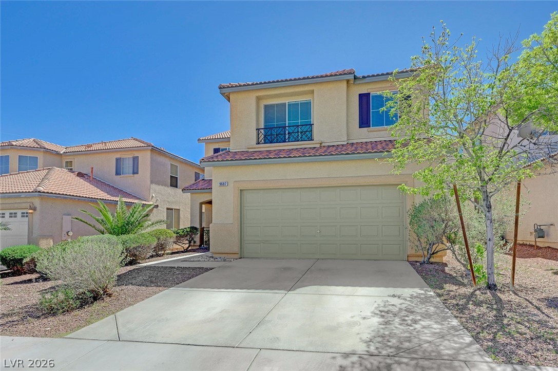 9687 Ridgebluff Avenue Las Vegas, NV 89148 - Photo 3 of 57 Mediterranean / spanish-style home with driveway, a garage, stucco siding, and a tile roof
