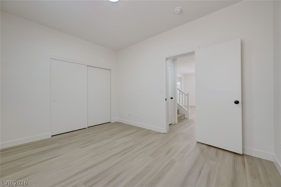 9687 Ridgebluff Avenue Las Vegas, NV 89148 - Photo 30 of 57 Unfurnished bedroom with light wood-type flooring and a closet