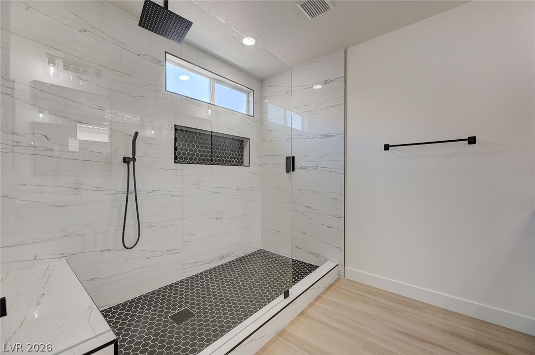 9687 Ridgebluff Avenue Las Vegas, NV 89148 - Photo 35 of 57 Full bath featuring a marble finish shower, light wood-style floors, and recessed lighting