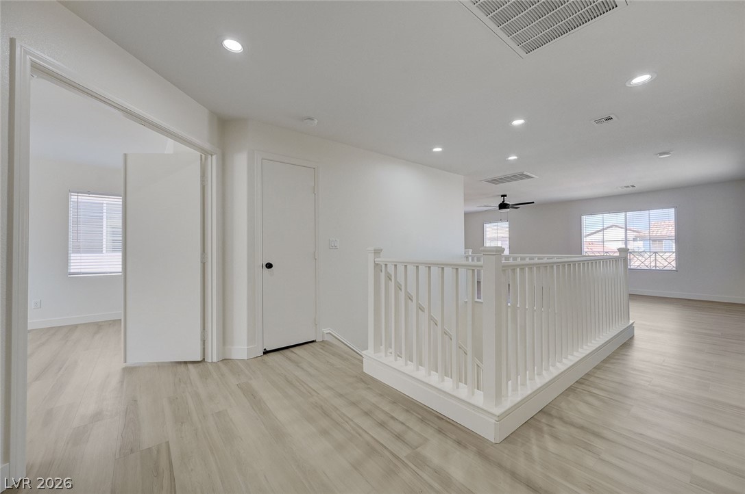 9687 Ridgebluff Avenue Las Vegas, NV 89148 - Photo 39 of 57 Hall with an upstairs landing, recessed lighting, and light wood-style floors