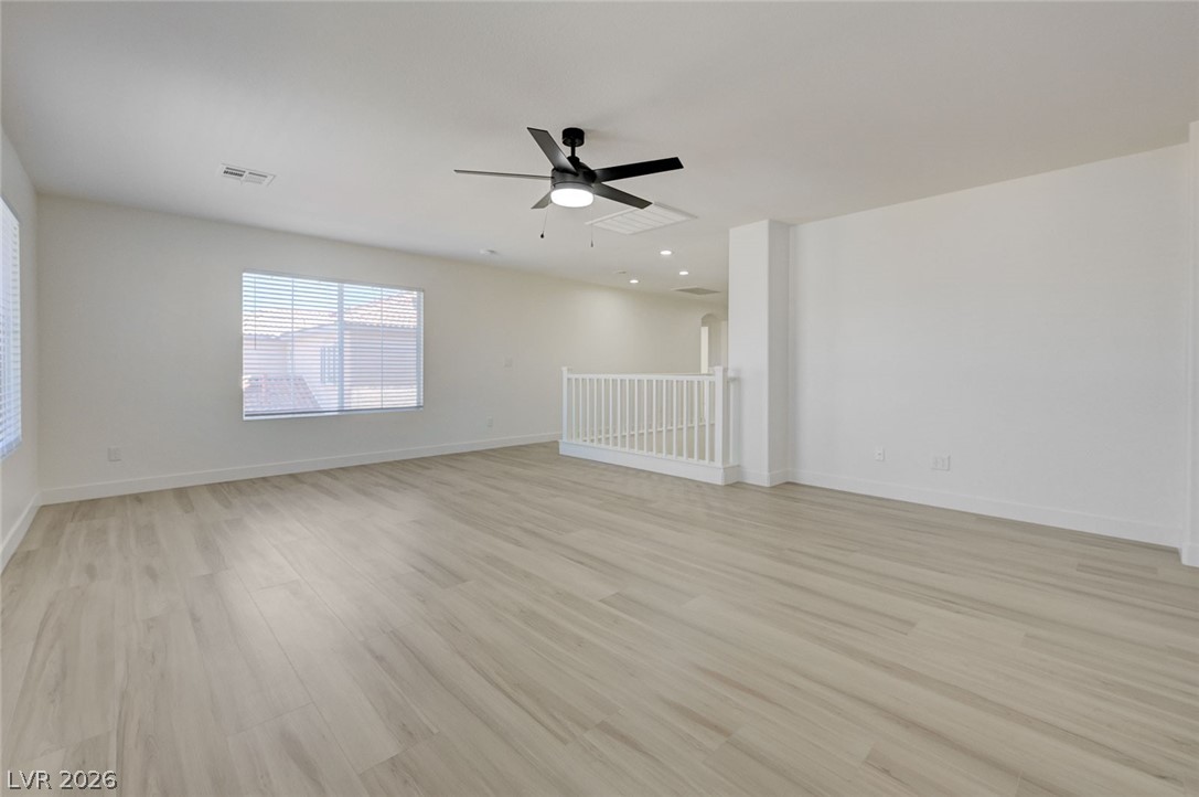 9687 Ridgebluff Avenue Las Vegas, NV 89148 - Photo 41 of 57 Spare room with a ceiling fan and light wood-style flooring