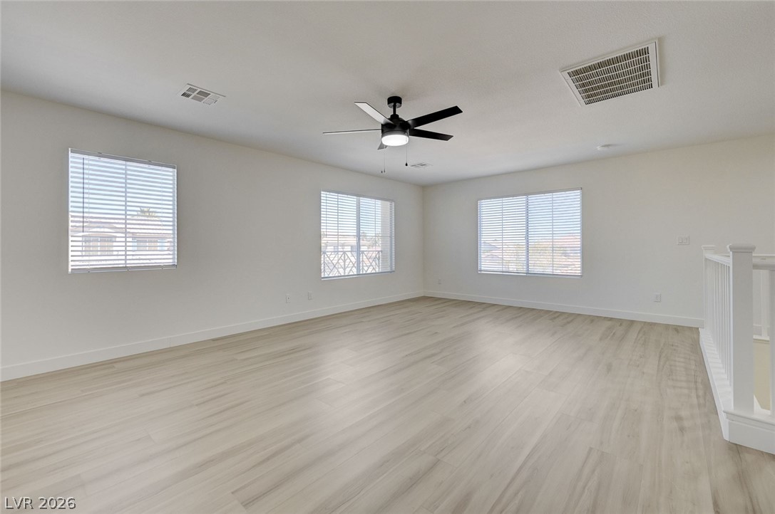 9687 Ridgebluff Avenue Las Vegas, NV 89148 - Photo 42 of 57 Empty room with light wood-style flooring and a ceiling fan