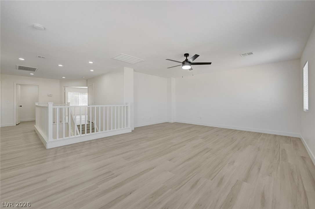 9687 Ridgebluff Avenue Las Vegas, NV 89148 - Photo 43 of 57 Empty room featuring light wood finished floors, ceiling fan, and recessed lighting