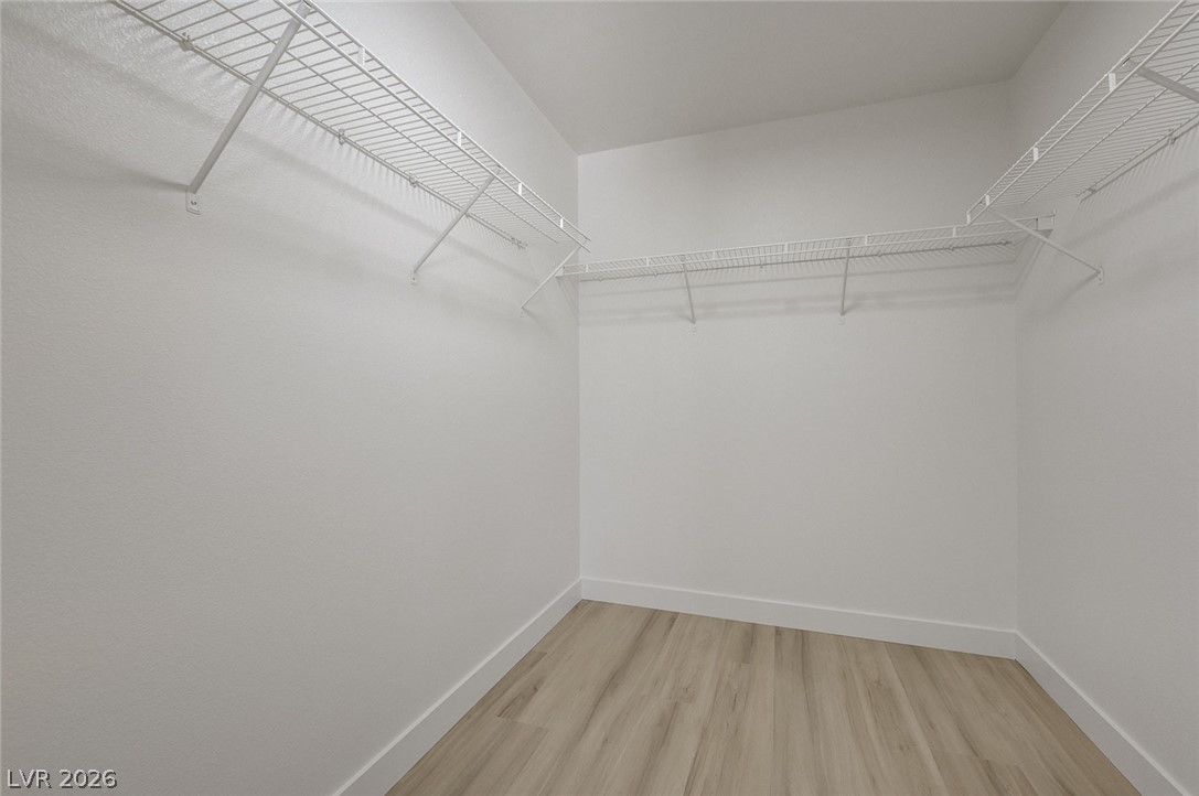 9687 Ridgebluff Avenue Las Vegas, NV 89148 - Photo 45 of 57 Walk in closet with light wood-style flooring