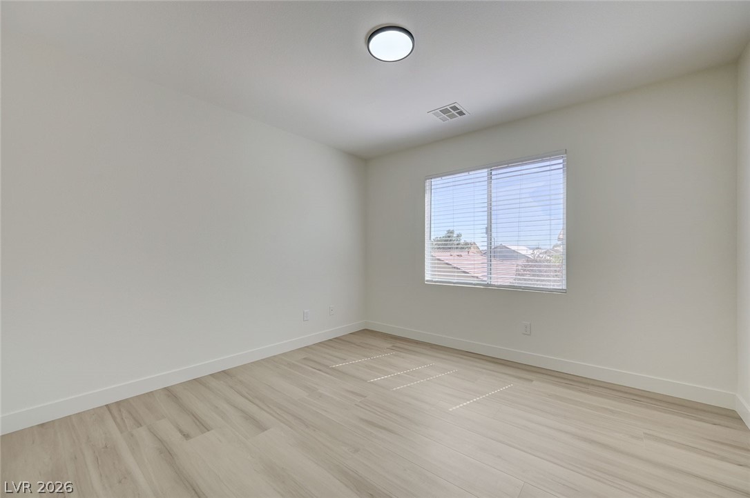 9687 Ridgebluff Avenue Las Vegas, NV 89148 - Photo 46 of 57 Unfurnished room with baseboards and light wood-style flooring